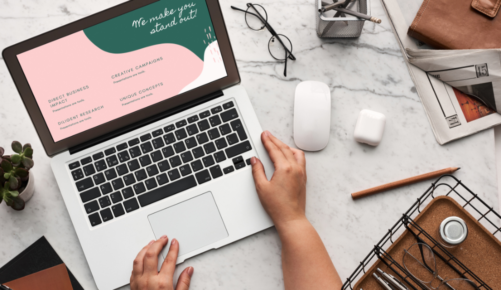 A laptop showing a digital marketing strategy with text such as "Direct Business Impact" and "Creative Campaigns," surrounded by office tools and accessories.